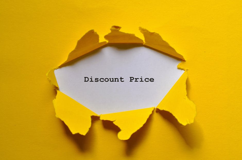 A close-up image of bright yellow paper with a torn edge revealing a white interior background. In the center, a piece of paper with typed black text reading 'Discount Price' is visible, suggesting a promotional offer. The torn paper creates a rough, jagged circular hole in the yellow sheet, casting subtle shadows around the edges, enhancing the three-dimensional effect. The background appears to be a solid yellow surface, complementing the torn paper's color and texture. This visual could relate to advertising or promotional materials, and the overall composition aligns with themes of marketing or special offers, naturally supporting the idea of alternative approaches to waste or rubbish management and disposal services offered by companies like Waste Disposal Chiswick.